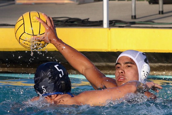 Lemoore's Daniel Bermea passes over Hanford West's Aiden Apgar in 13-12 loss Tuesday in Hanford.